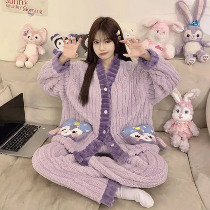 Person wearing a purple robe with cartoon character pockets, sitting on a couch with stuffed animals.