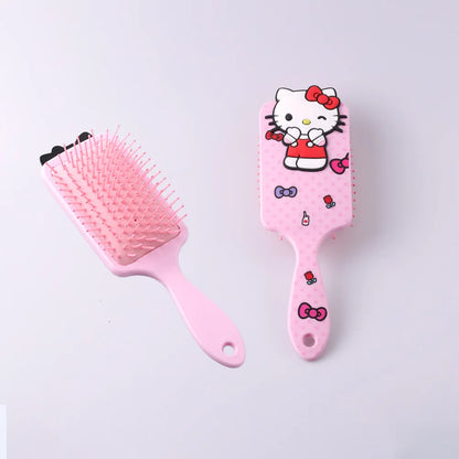 Pink hairbrush with Hello Kitty design on a light gray background