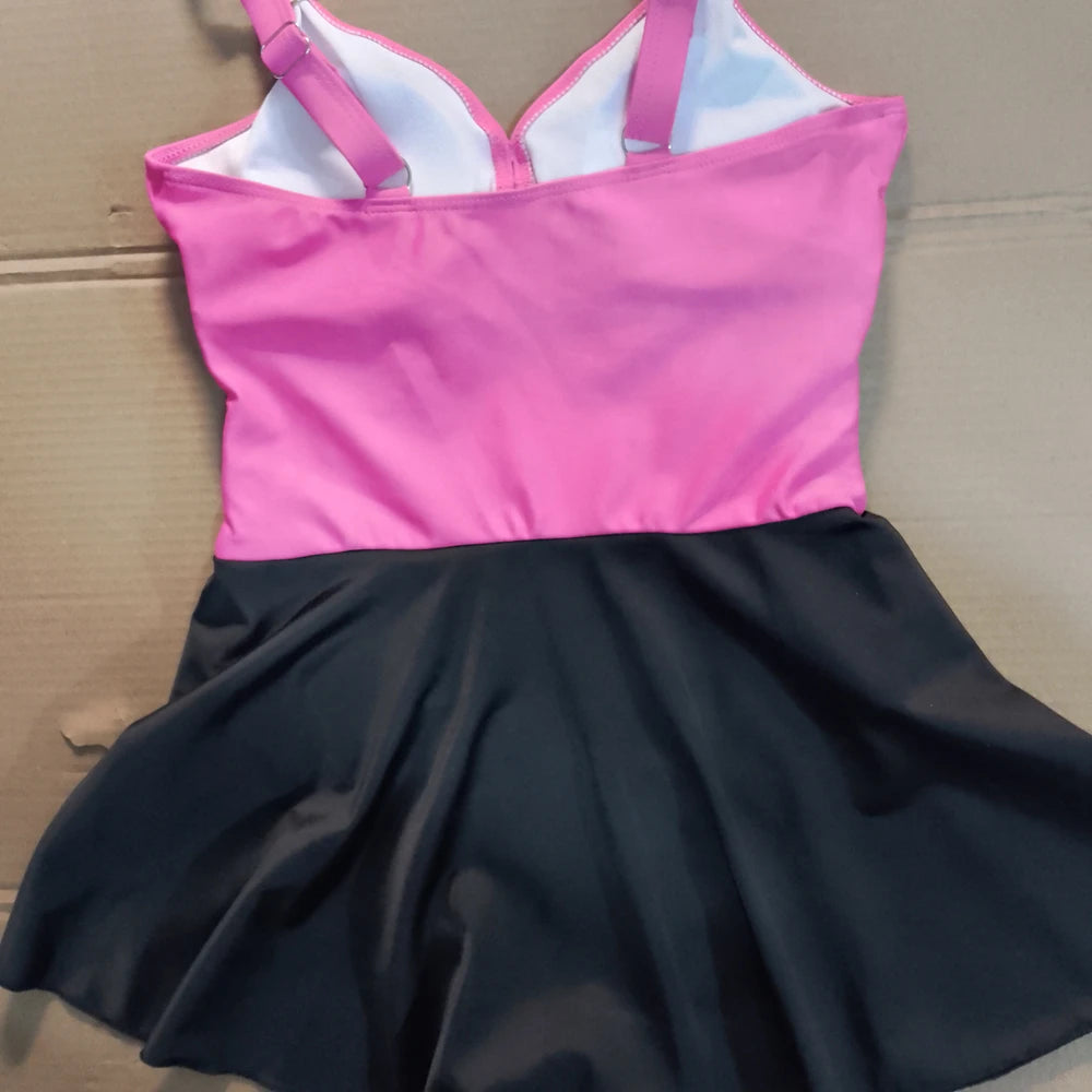 Pink and black dress on a cardboard surface