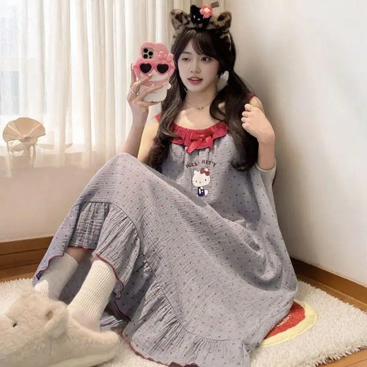 Woman in a Hello Kitty dress sitting on the floor with a phone case featuring a cat design.