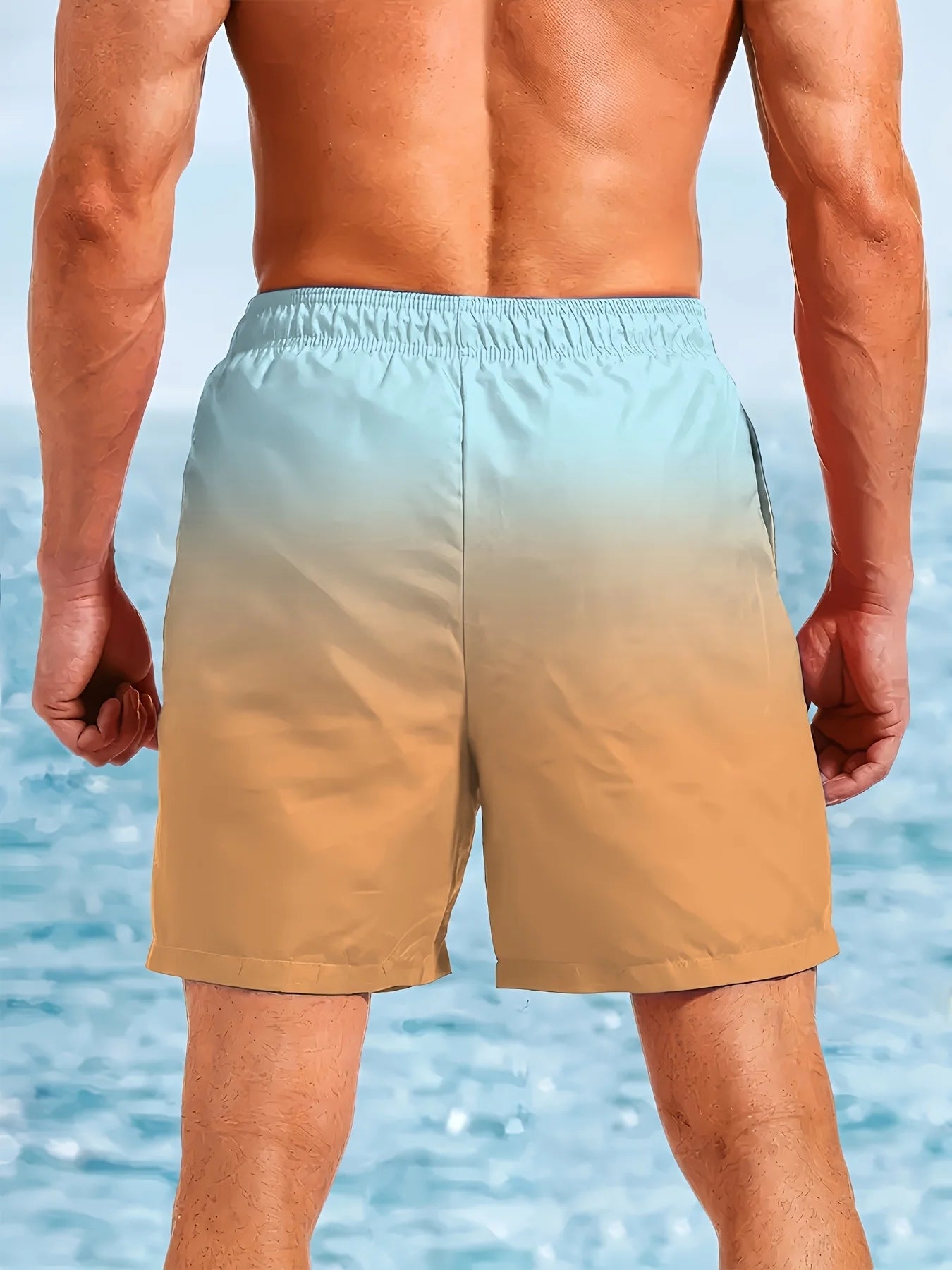 Person wearing a gradient swim shorts with a beach background