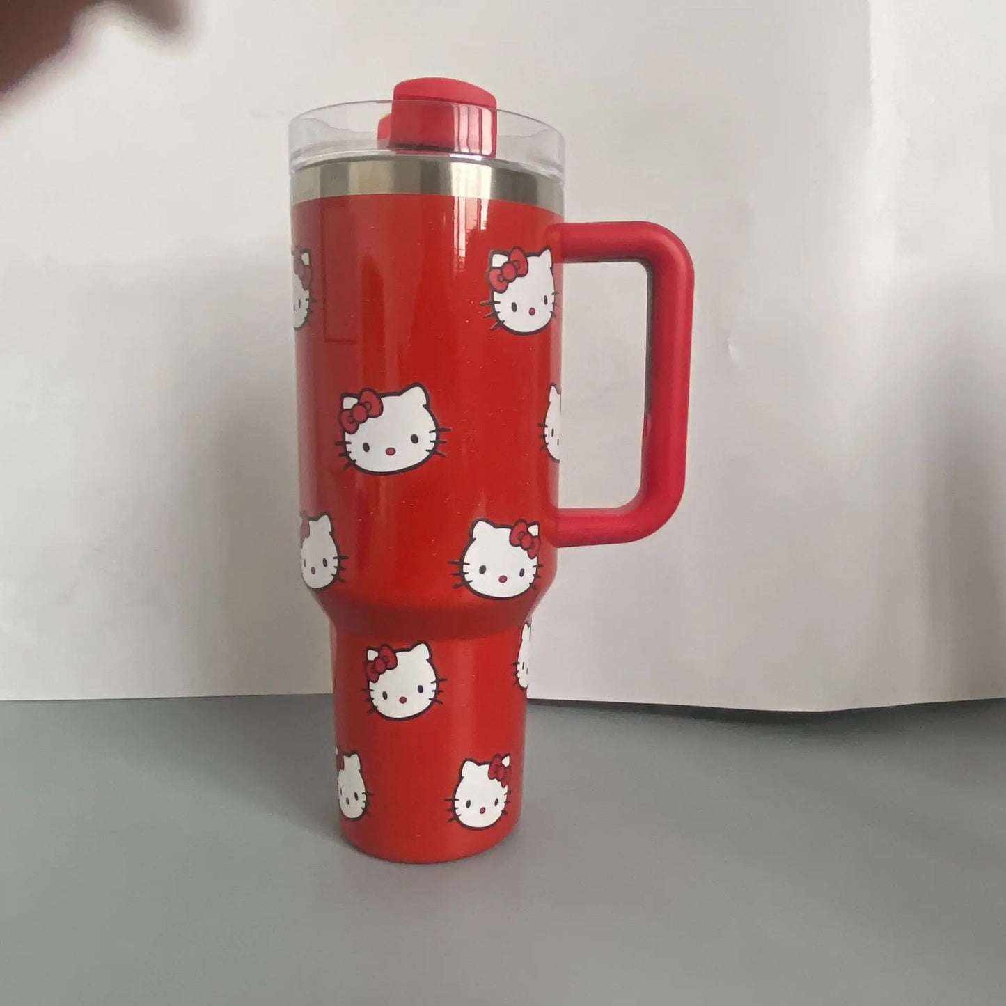 Red tumbler with Hello Kitty design on a white background