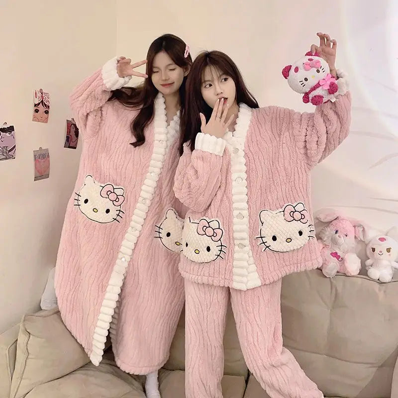 Two people wearing pink Hello Kitty pajamas in a cozy room.