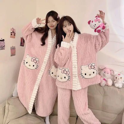 Two people wearing pink Hello Kitty pajamas in a cozy room.