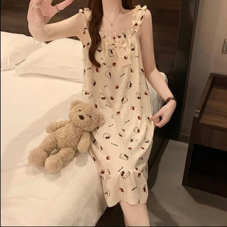 Woman in a patterned dress holding a teddy bear on a bed