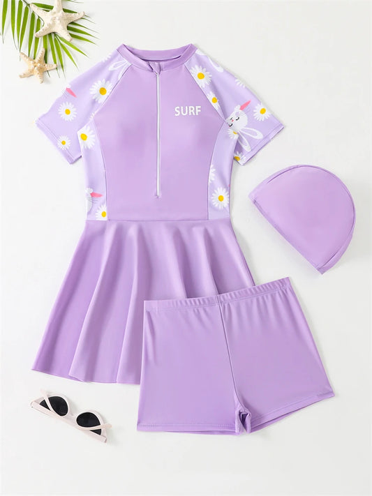 Purple children's swimsuit set with matching cap on a white background
