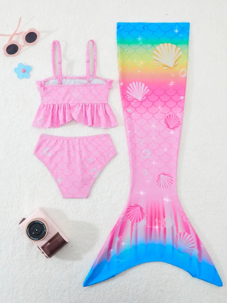 Pink mermaid tail swimsuit with shell pattern on a white background