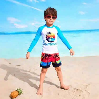 Child wearing a colorful beach outfit with a palm tree design on a sandy beach.