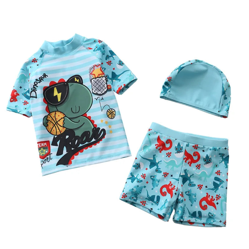 Children's swim set with shirt, shorts, and cap featuring dinosaur designs on a white background.