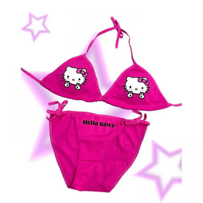 Pink Hello Kitty bikini set on a white background with decorative stars.