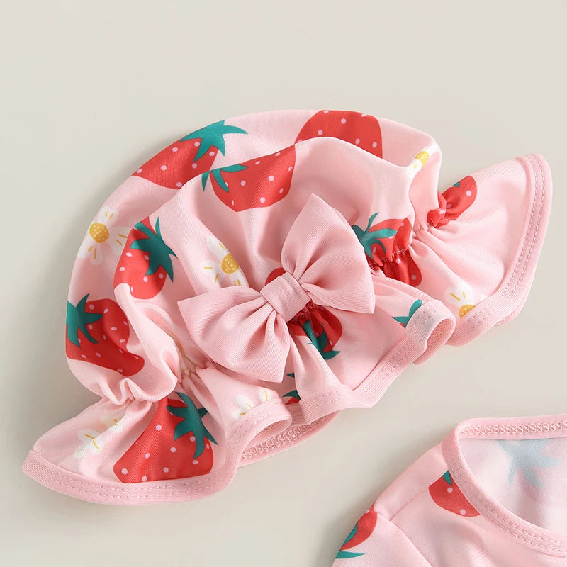 Pink shower cap with strawberry pattern on a light gray background
