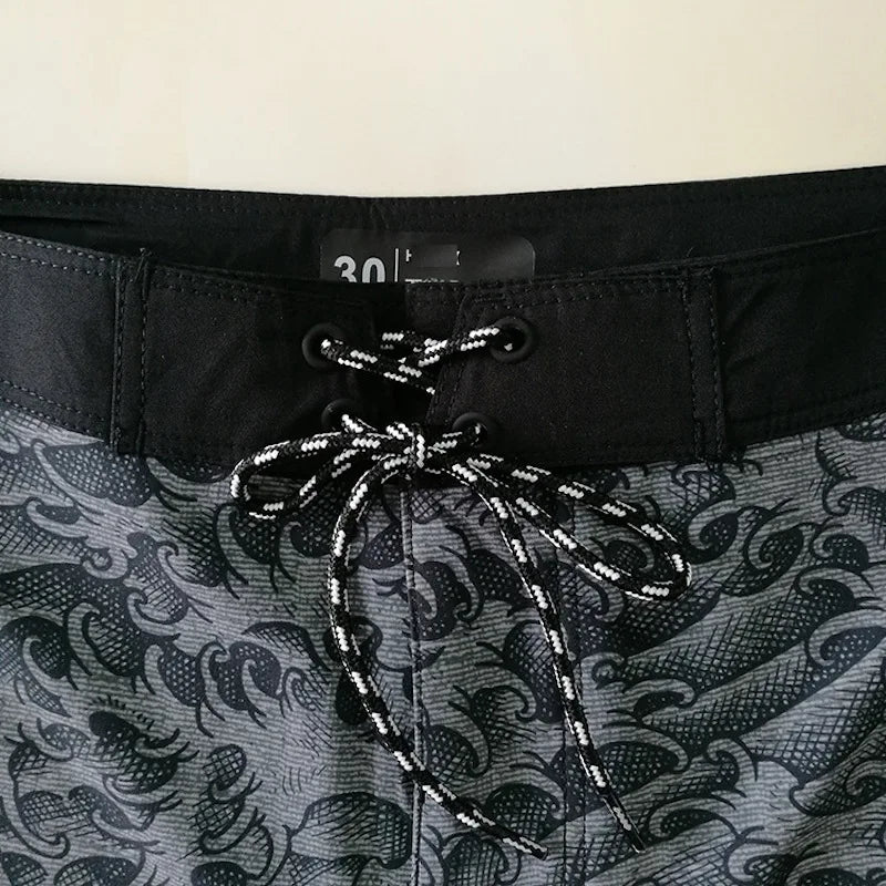 Close-up of a patterned swimsuit with a drawstring and waistband detail.