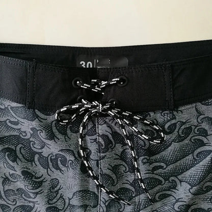 Close-up of a patterned swimsuit with a drawstring and waistband detail.