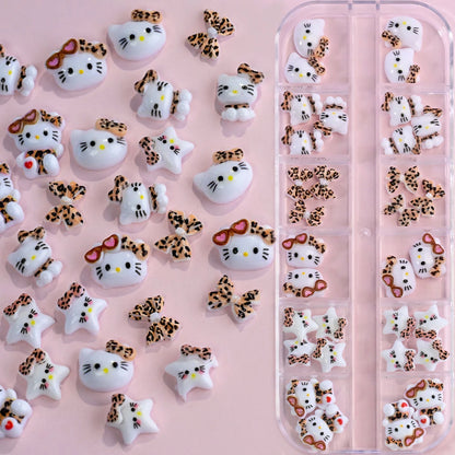 Set of Hello Kitty-themed nail art decorations on a pink background