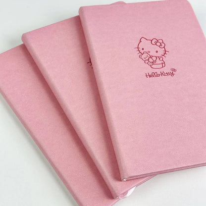 Three pink notebooks with Hello Kitty logo on a white background