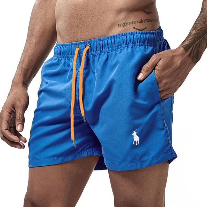 Blue swim shorts with orange drawstring on a white background