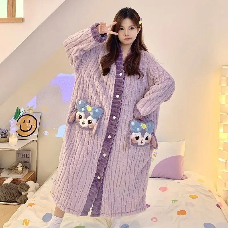 Person wearing a long, light purple robe with cartoon character pockets in a cozy room.