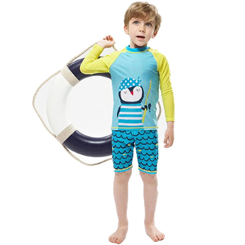 Child wearing a blue and yellow penguin-themed swimsuit with a life buoy on a white background