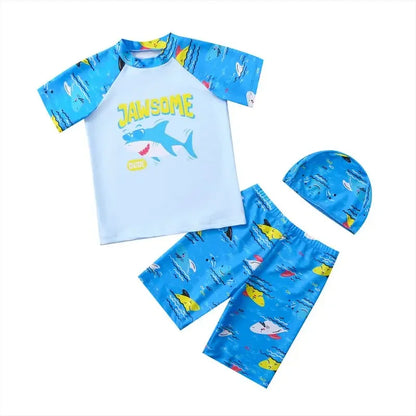 Children's shark-themed swim set with shirt, shorts, and hat on a white background