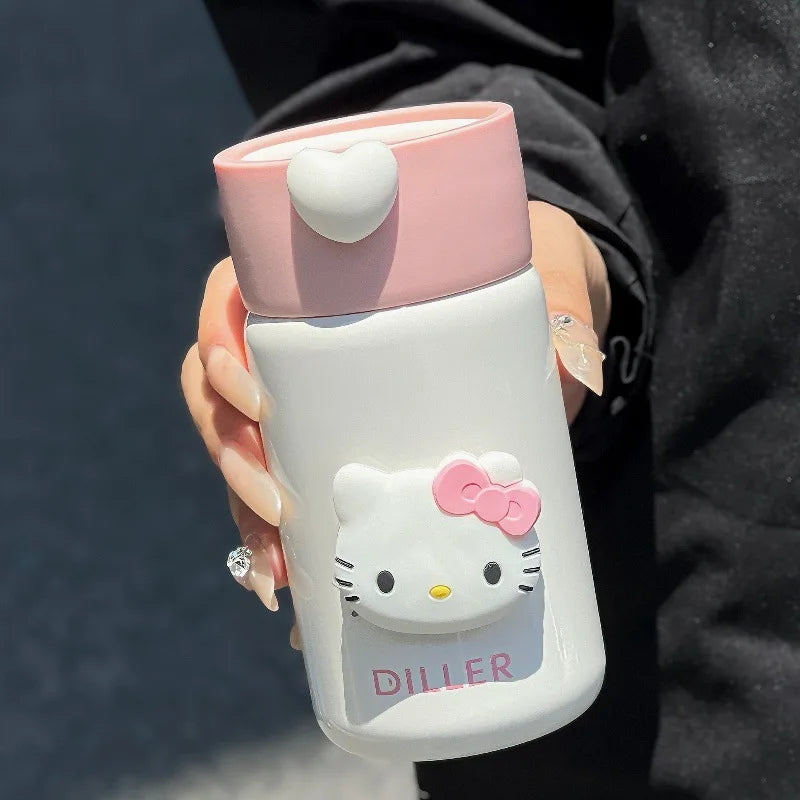 Hand holding a Hello Kitty-themed water bottle with pink cap