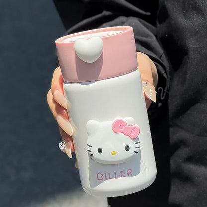 Hand holding a Hello Kitty-themed water bottle with pink cap