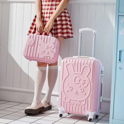 Person holding a pink suitcase with a bunny design in a room.