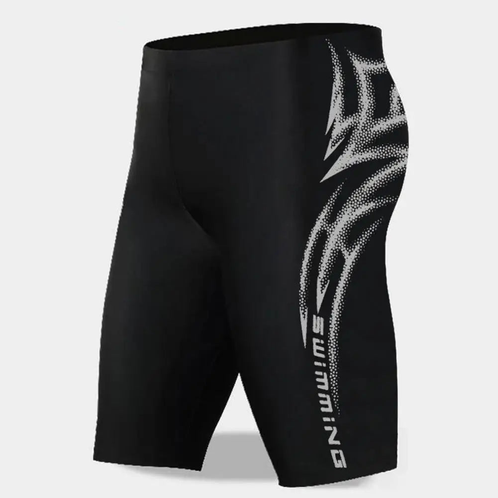 Black swim shorts with white logo on a light gray background