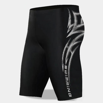 Black swim shorts with white logo on a light gray background