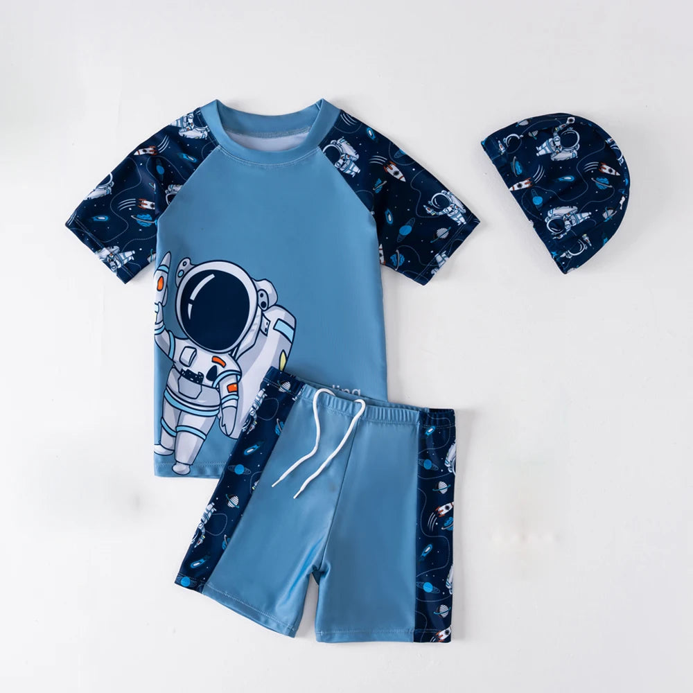 Children's outfit with blue astronaut-themed shirt, shorts, and hat on a white background
