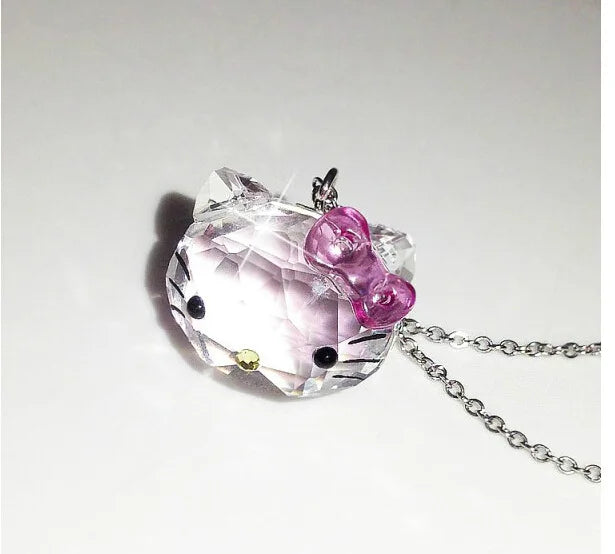 Crystal pendant with pink bow on a white background