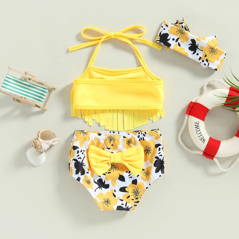 Yellow bikini set with floral details on a light gray background