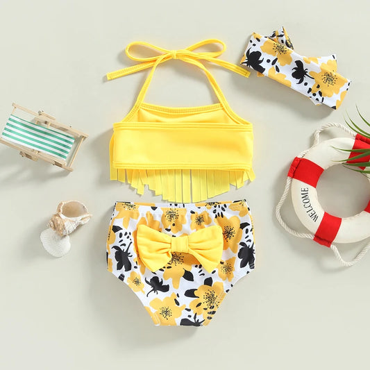 Yellow bikini set with floral details on a light gray background