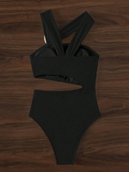 Black swimsuit on a wooden surface