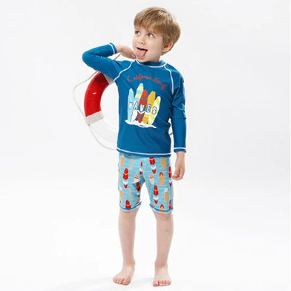 Child wearing a blue rash guard with surfboard design and colorful swim shorts on a white background