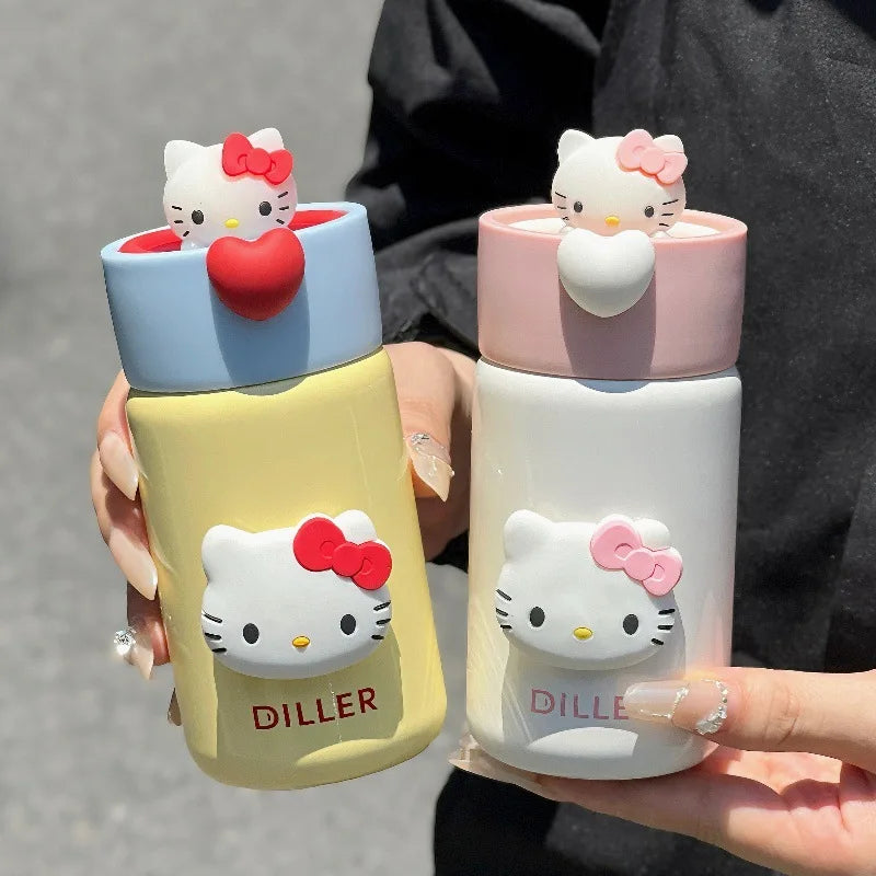 Two colorful water bottles with Hello Kitty designs held by a person.