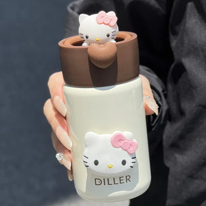 Hello Kitty-themed bottle with a small figure on top, held by a person against a dark background.