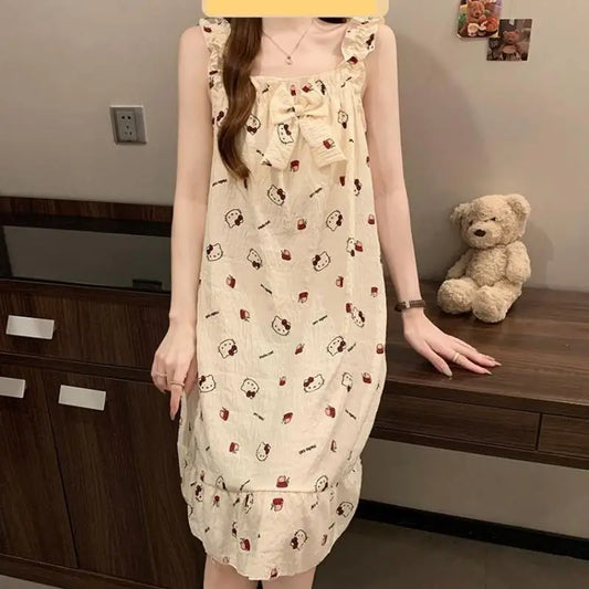 Woman wearing a patterned dress standing in a room with a teddy bear on a shelf.