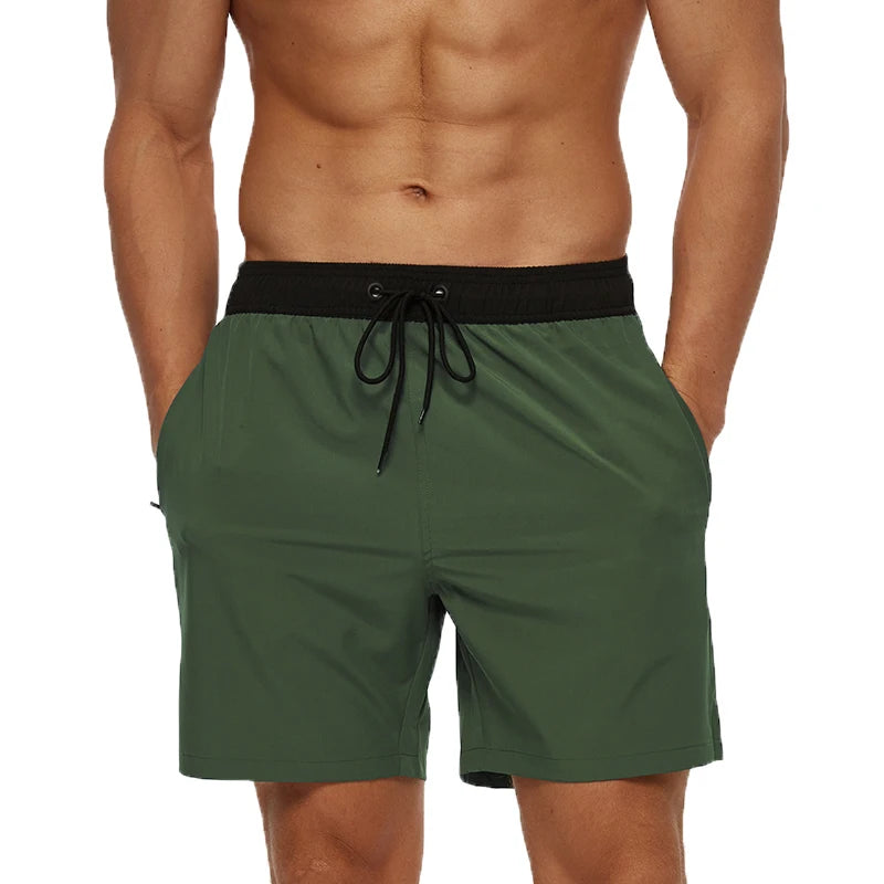 Green shorts with a black waistband on a white background
