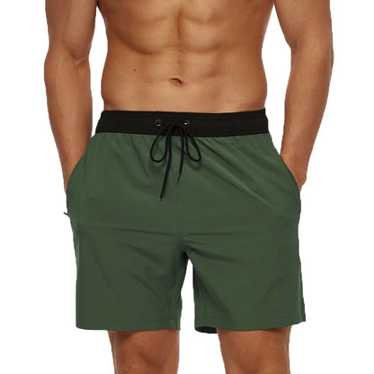 Green shorts with a black waistband on a white background