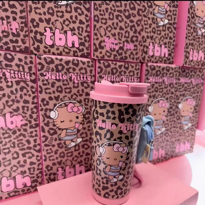 Pink tumbler with leopard print design featuring Hello Kitty character against a pink background with text and graphics.