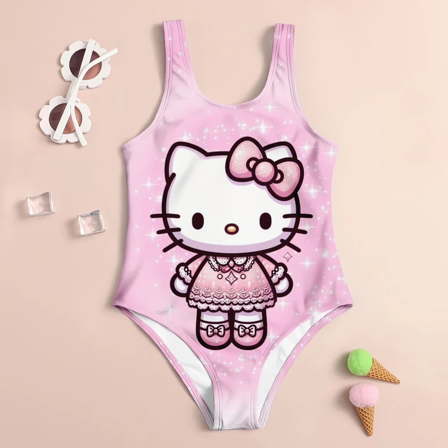 Pink children's swimsuit with Hello Kitty design on a beige background