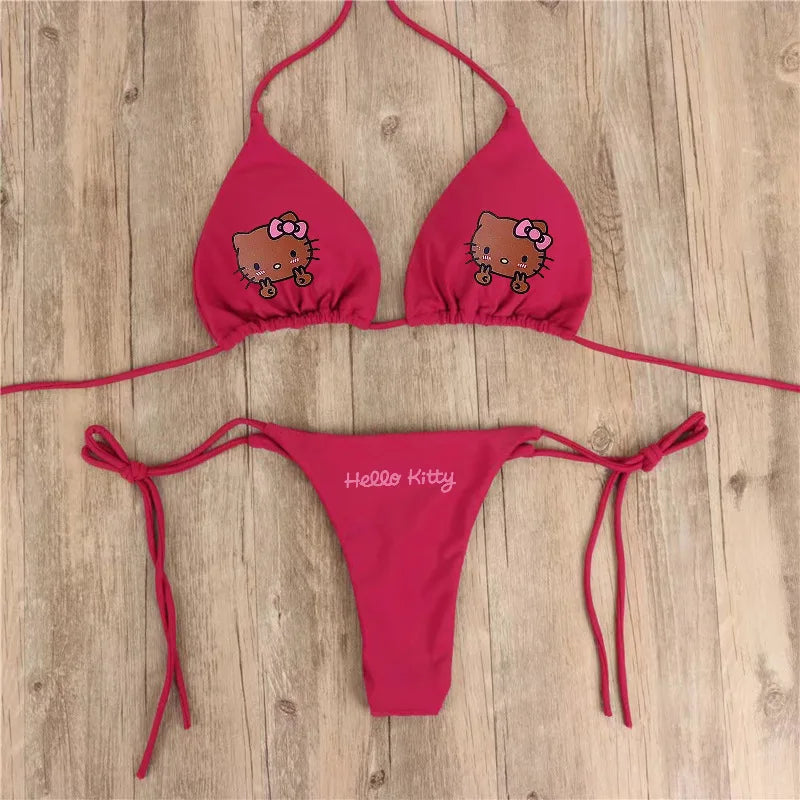 Red bikini set with Hello Kitty design on a wooden surface