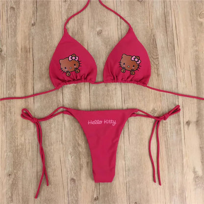 Red bikini set with Hello Kitty design on a wooden surface