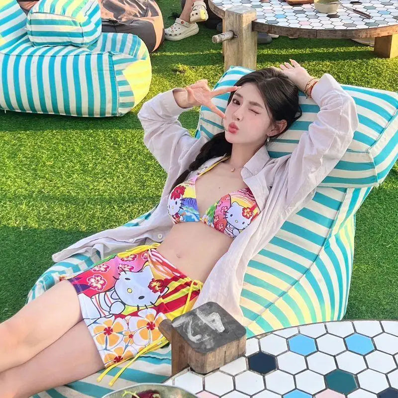 Woman in a colorful bikini lying on a striped lounge chair outdoors.