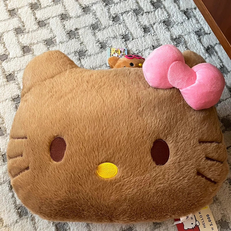 Plush toy resembling a cat with a pink bow on a checkered background