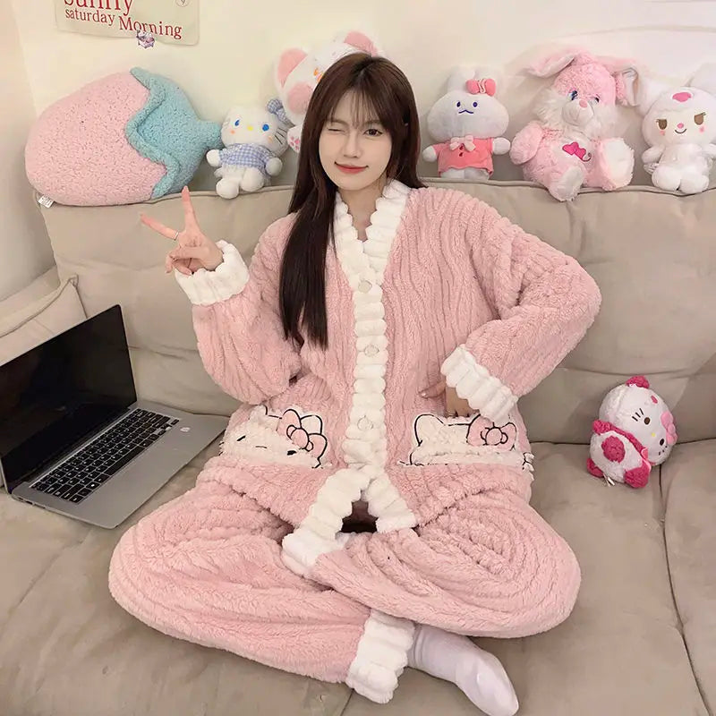 Person wearing a pink plush robe with cartoon designs, sitting on a couch with stuffed toys in the background.