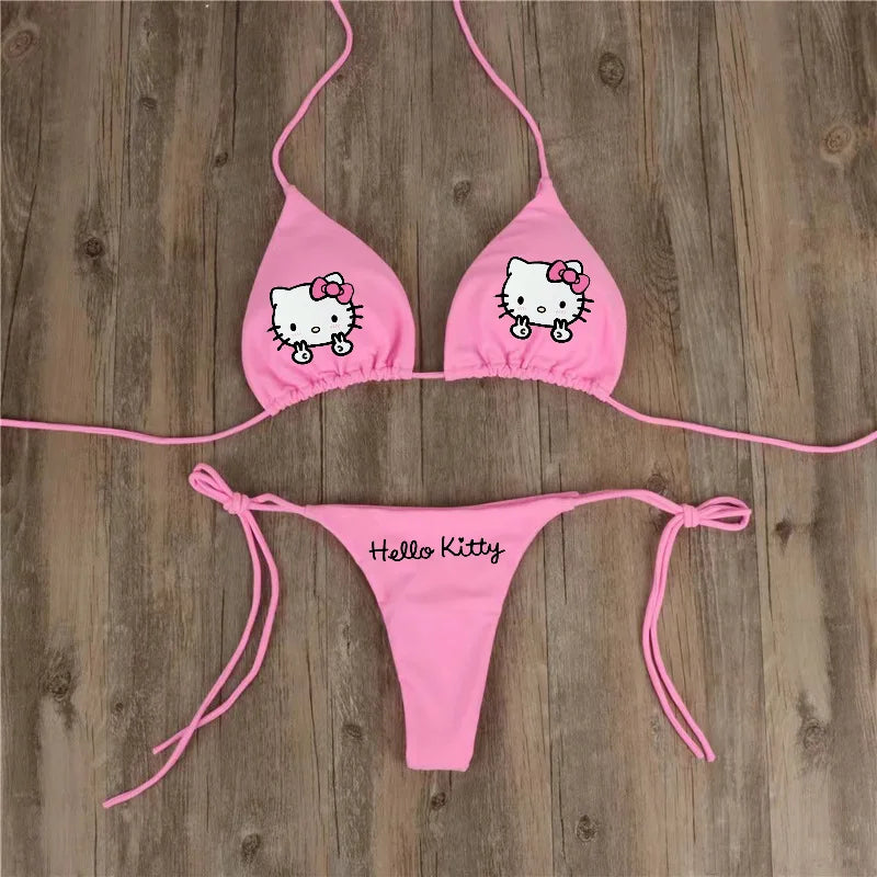 Pink Hello Kitty bikini set on a wooden background