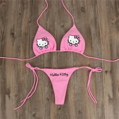 Pink Hello Kitty bikini set on a wooden background