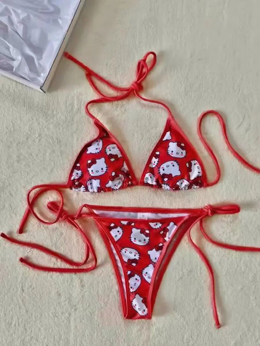 Red bikini set with cartoon pattern on a beige surface