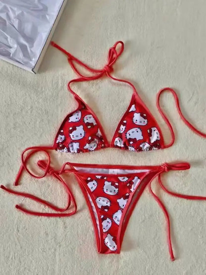 Red bikini set with cartoon pattern on a beige surface